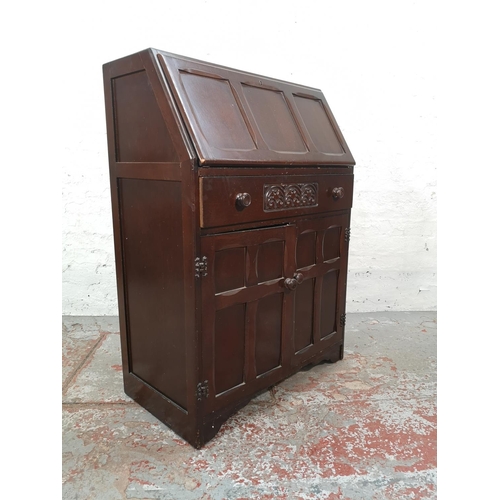 1042 - A mid 20th century oak bureau with two lower cupboard doors, single drawer and fall front - approx. ... 