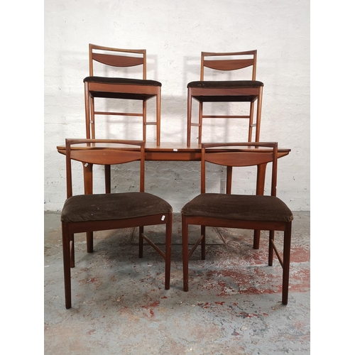 1046 - An A.H. McIntosh teak extending dining table and four matching chairs - approx. 74cm high x 91cm wid... 