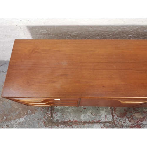 1047 - An A.H. McIntosh teak sideboard with three drawers and three cupboard doors - approx. 75cm high x 20... 