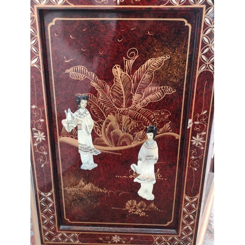 1051 - An Oriental red lacquered hexagonal display cabinet with mother of pearl Geisha girl design and two ... 