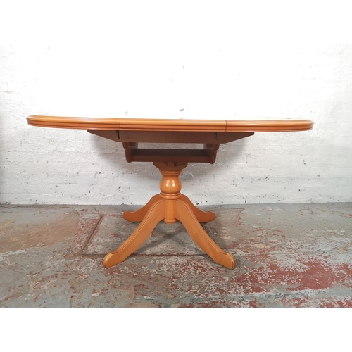 1057 - A modern beech circular extending dining table and four matching chairs - approx. 76cm high x 108cm ... 