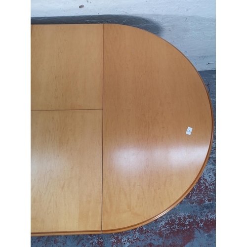 1057 - A modern beech circular extending dining table and four matching chairs - approx. 76cm high x 108cm ... 