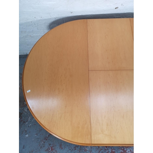 1057 - A modern beech circular extending dining table and four matching chairs - approx. 76cm high x 108cm ... 