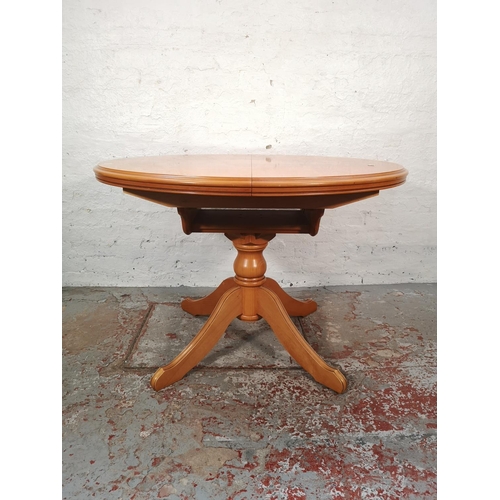 1057 - A modern beech circular extending dining table and four matching chairs - approx. 76cm high x 108cm ... 