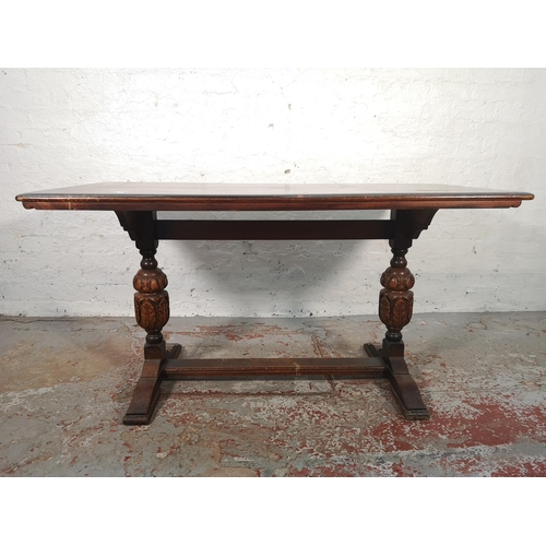 1058 - A 17th century style oak rectangular dining table with carved twin baluster supports and four Cromwe... 