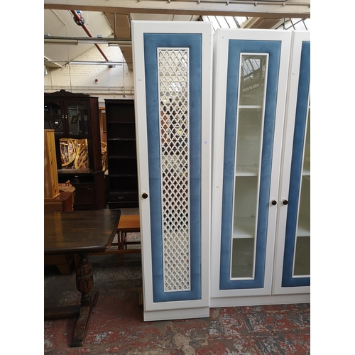 1059 - A contemporary white painted and blue fabric mirrored door wardrobe with four internal shelves - app... 