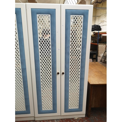 1063 - A contemporary white painted and blue fabric double mirrored door wardrobe - approx. 208cm high x 10... 