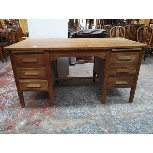 1065 - A mid 20th century oak pedestal desk with six short drawers and one long drawer - approx. 78cm high ... 