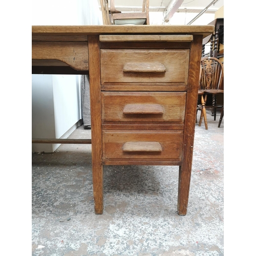 1065 - A mid 20th century oak pedestal desk with six short drawers and one long drawer - approx. 78cm high ... 