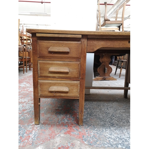 1065 - A mid 20th century oak pedestal desk with six short drawers and one long drawer - approx. 78cm high ... 