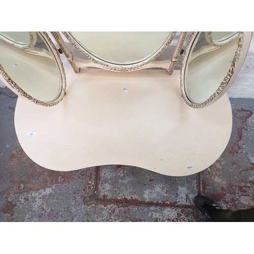 1066 - A French style cream painted kidney shaped dressing table with upper oval three section mirror and t... 