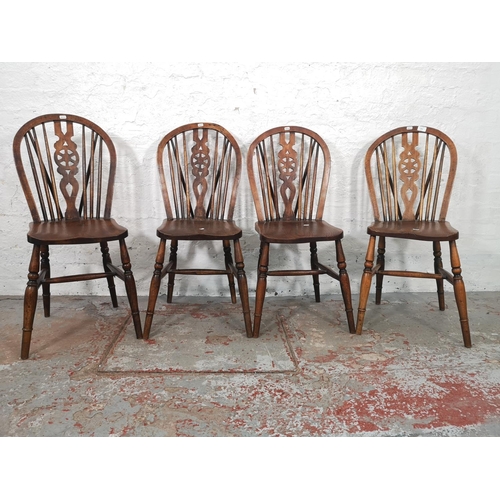 1067 - A set of four Victorian style elm and beech wheel back dining chairs - approx. 92cm high x 35cm wide... 