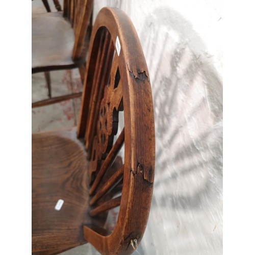 1067 - A set of four Victorian style elm and beech wheel back dining chairs - approx. 92cm high x 35cm wide... 