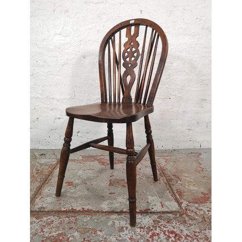 1067 - A set of four Victorian style elm and beech wheel back dining chairs - approx. 92cm high x 35cm wide... 