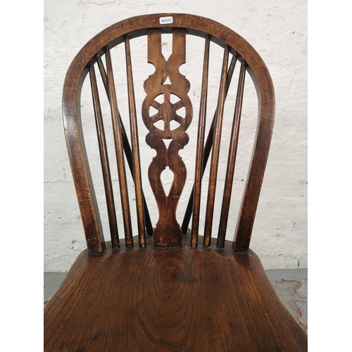 1067 - A set of four Victorian style elm and beech wheel back dining chairs - approx. 92cm high x 35cm wide... 