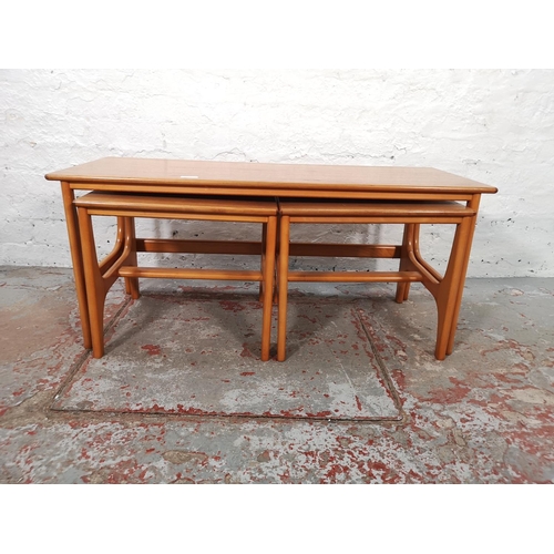 1071 - A teak and beech nest of three tables - largest approx. 44cm high x 40cm wide x 100cm long