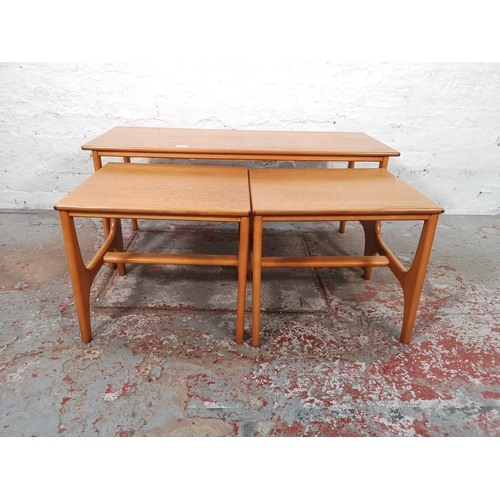 1071 - A teak and beech nest of three tables - largest approx. 44cm high x 40cm wide x 100cm long