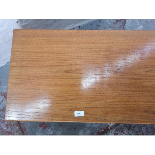 1071 - A teak and beech nest of three tables - largest approx. 44cm high x 40cm wide x 100cm long