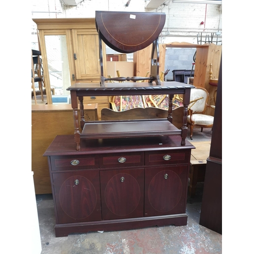 1075 - Three pieces of mahogany effect furniture, one drop leaf swivel top side table with lyre end support... 