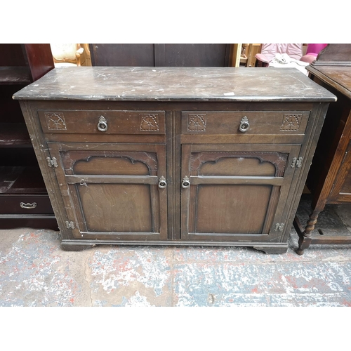 1080 - A late 20th century oak sideboard with two drawers and two cupboard doors - approx. 90cm high x 125c... 