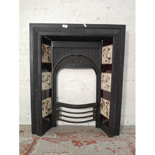 1083 - A Victorian Biclam cast iron fire surround with ceramic tiles - approx. 92cm high x 76.5cm wide x 17... 