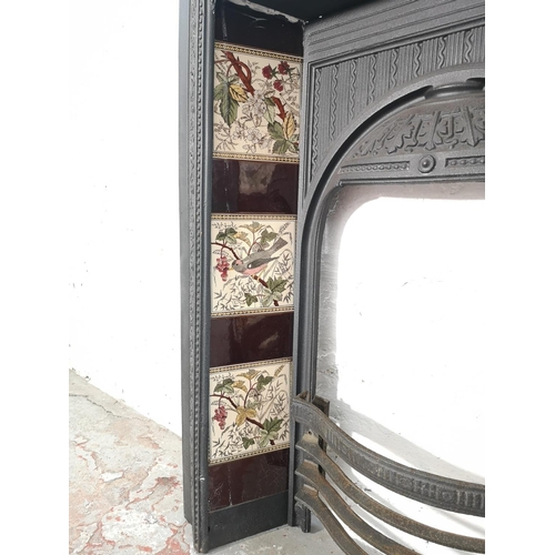 1083 - A Victorian Biclam cast iron fire surround with ceramic tiles - approx. 92cm high x 76.5cm wide x 17... 