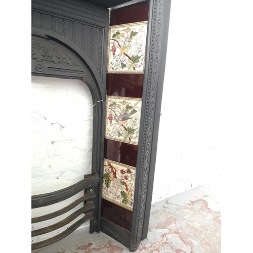 1083 - A Victorian Biclam cast iron fire surround with ceramic tiles - approx. 92cm high x 76.5cm wide x 17... 