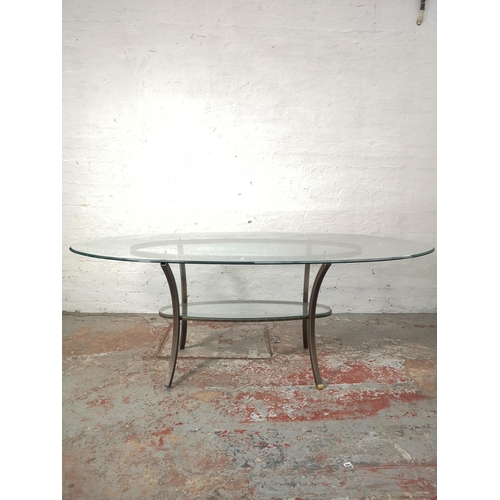 1084 - A contemporary wrought iron two tier oval dining table with bevelled glass top - approx. 76cm high x... 