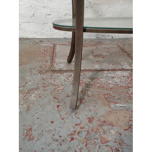 1084 - A contemporary wrought iron two tier oval dining table with bevelled glass top - approx. 76cm high x... 