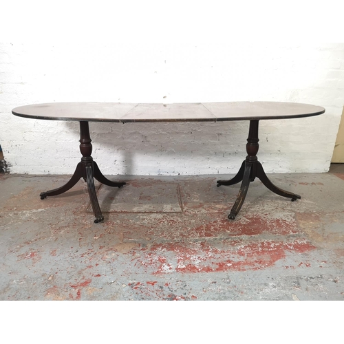 1086 - A Regency style mahogany oval extending dining table with six matching chairs - approx. 74.5cm high ... 