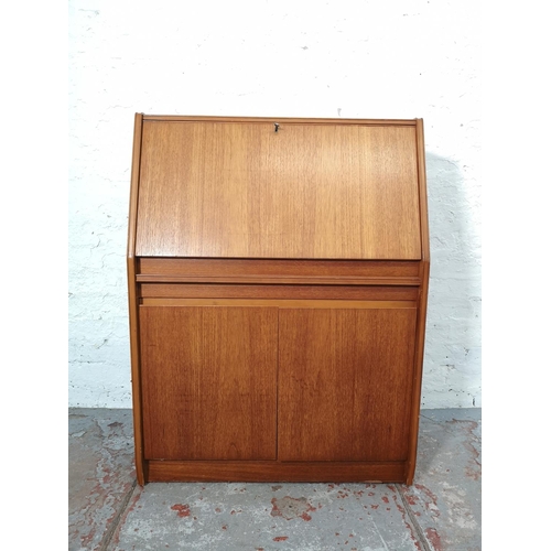 1092 - A Remploy teak bureau with two lower cupboard doors, single drawer and fall front - approx. 102cm hi... 