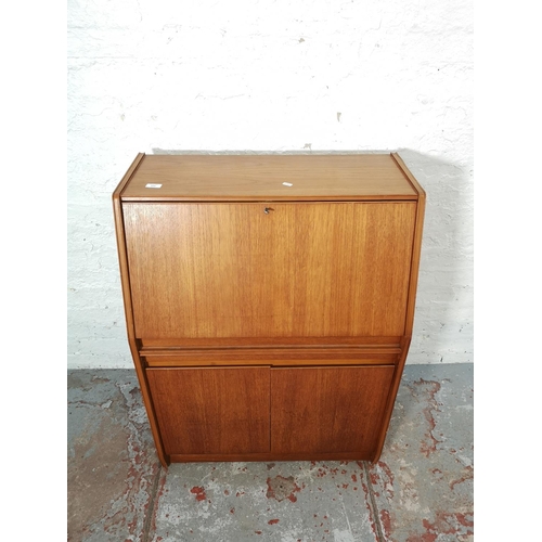 1092 - A Remploy teak bureau with two lower cupboard doors, single drawer and fall front - approx. 102cm hi... 