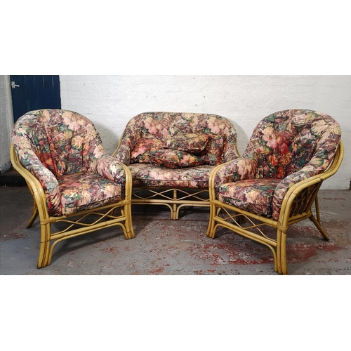 1100 - A mid/late 20th century bamboo three piece conservatory suite comprising two armchairs and sofa