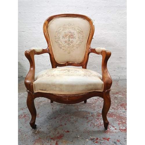 1101 - A Victorian walnut armchair with floral tapestry upholstery and casters - approx. 98cm high x 61cm w... 