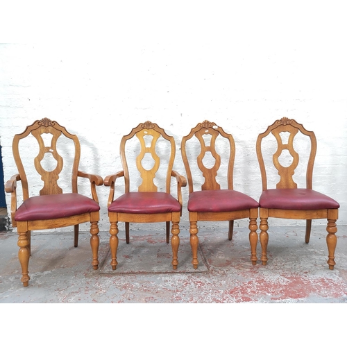 1102 - A set of four late 20th century oak and red vinyl dining chairs