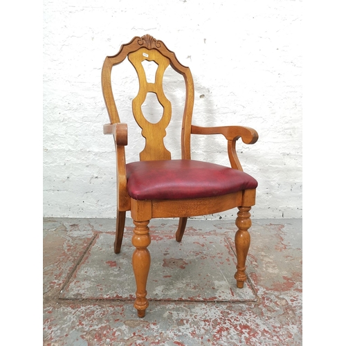 1102 - A set of four late 20th century oak and red vinyl dining chairs