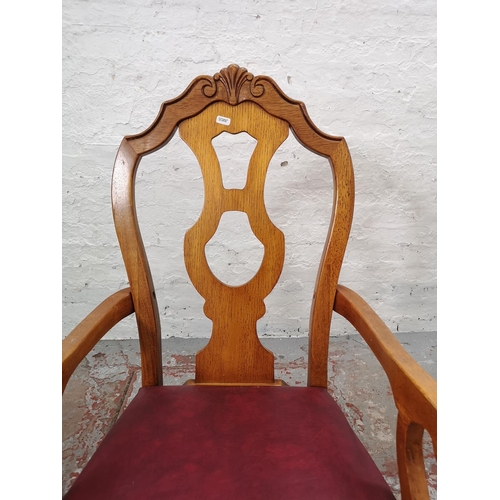 1102 - A set of four late 20th century oak and red vinyl dining chairs