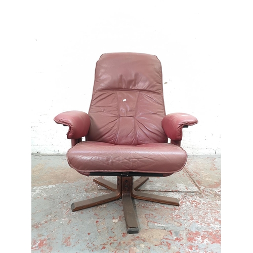 1104 - A Unico red leather swivel armchair - approx. 102cm high x 78cm wide x 70cm deep