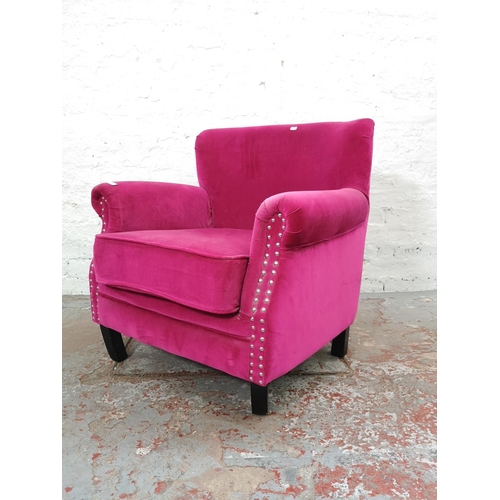 1105 - A modern pink upholstered metal studded armchair with similar circular footstool - Chair approx. 78c... 