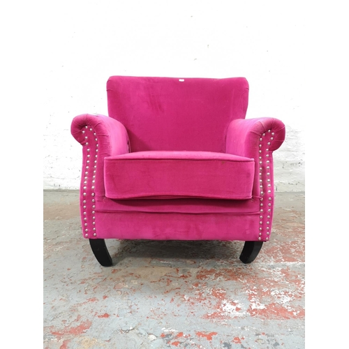 1105 - A modern pink upholstered metal studded armchair with similar circular footstool - Chair approx. 78c... 