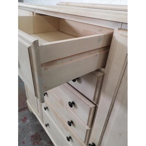 1109 - A Ducal white painted pine sideboard with six central drawers and two outer cupboard doors - approx.... 