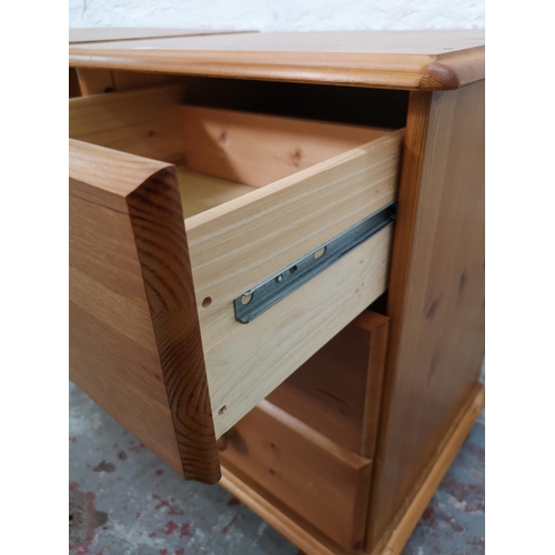 1111 - A pair of modern pine bedside chests of three drawers - approx. 59cm high x 44cm wide x 38cm deep