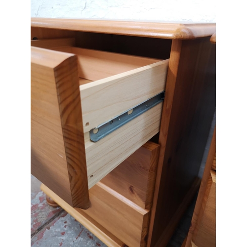 1111 - A pair of modern pine bedside chests of three drawers - approx. 59cm high x 44cm wide x 38cm deep