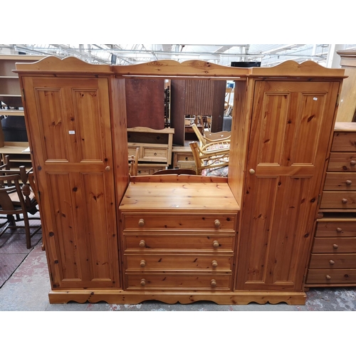 1114 - A large modern pine double wardrobe with four central drawers - approx. 193cm high x 217cm wide x 66... 