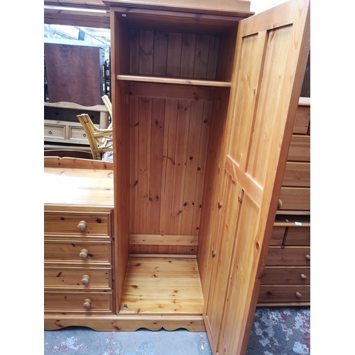 1114 - A large modern pine double wardrobe with four central drawers - approx. 193cm high x 217cm wide x 66... 