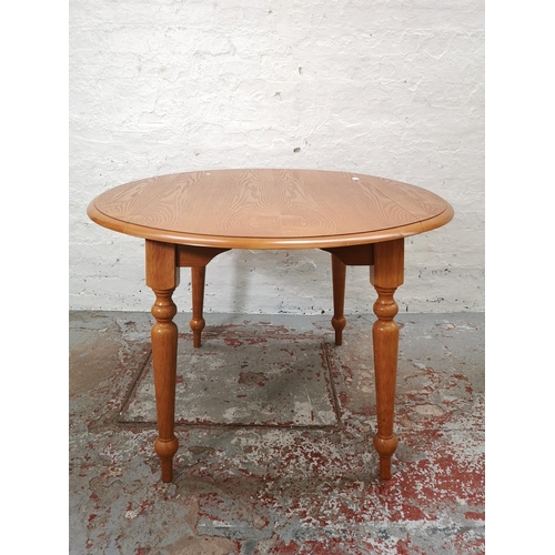 1117 - A modern oak drop leaf farmhouse style kitchen table with four matching floral upholstered spindle b... 