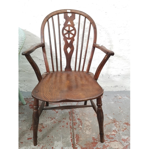 1117E - Two chairs, one Victorian style elm and beech wheel back carver dining chair and one vintage Lloyd L... 