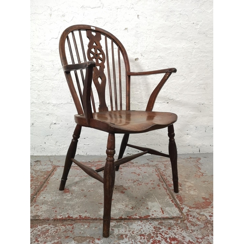 1117E - Two chairs, one Victorian style elm and beech wheel back carver dining chair and one vintage Lloyd L... 