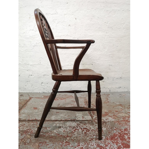 1117E - Two chairs, one Victorian style elm and beech wheel back carver dining chair and one vintage Lloyd L... 