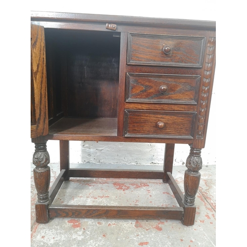 1132 - A Jaycee oak side cabinet with three drawers and one cupboard door - approx. 73cm high x 65cm wide x... 